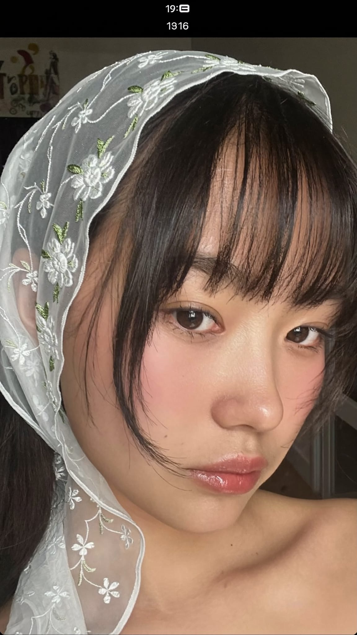 Asian woman with see-through wispy sheer bangs wearing a sheer lace flower embroidery bandana headband