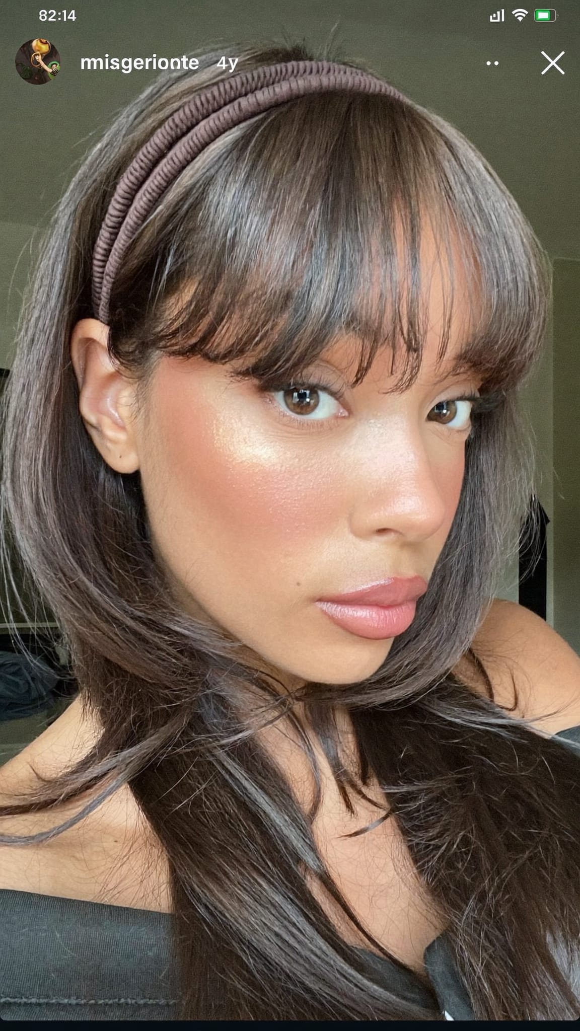 Mixed-race woman with butterfly-cut layered bangs wearing a boho non-slip elastic triangle headband pushed high on her head