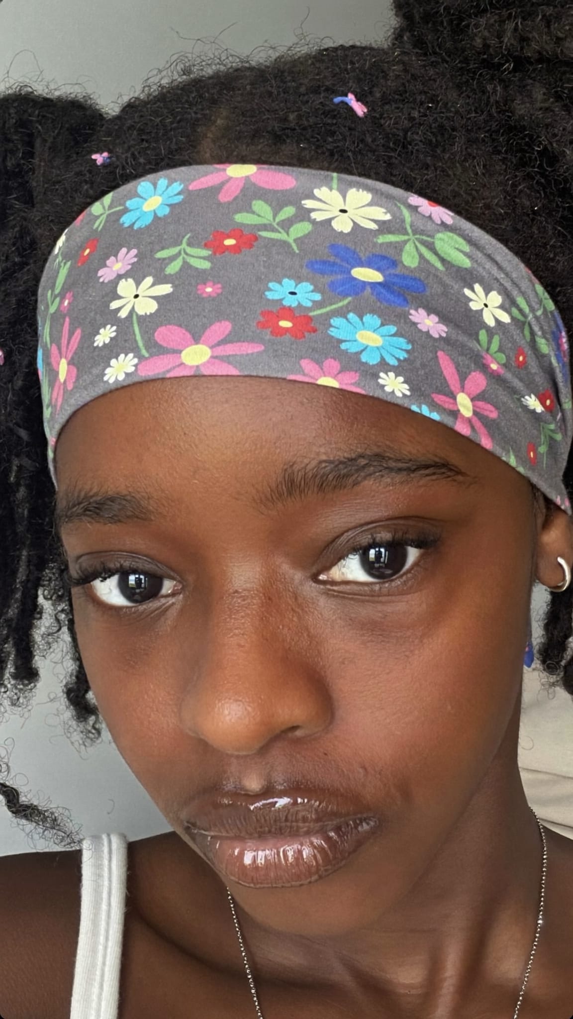 Young Black teen with textured natural hair wearing a soft cotton floral bandana as a wide headband